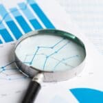 Magnifying,glass,on,graph,paper ,financial,development,,banking,account,,statistics,