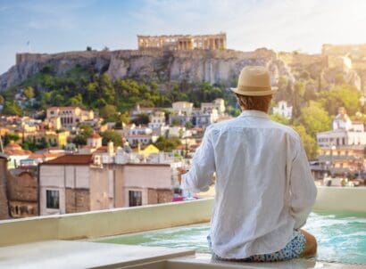 A,tourist,man,sitting,by,the,pool,enjoys,the,view