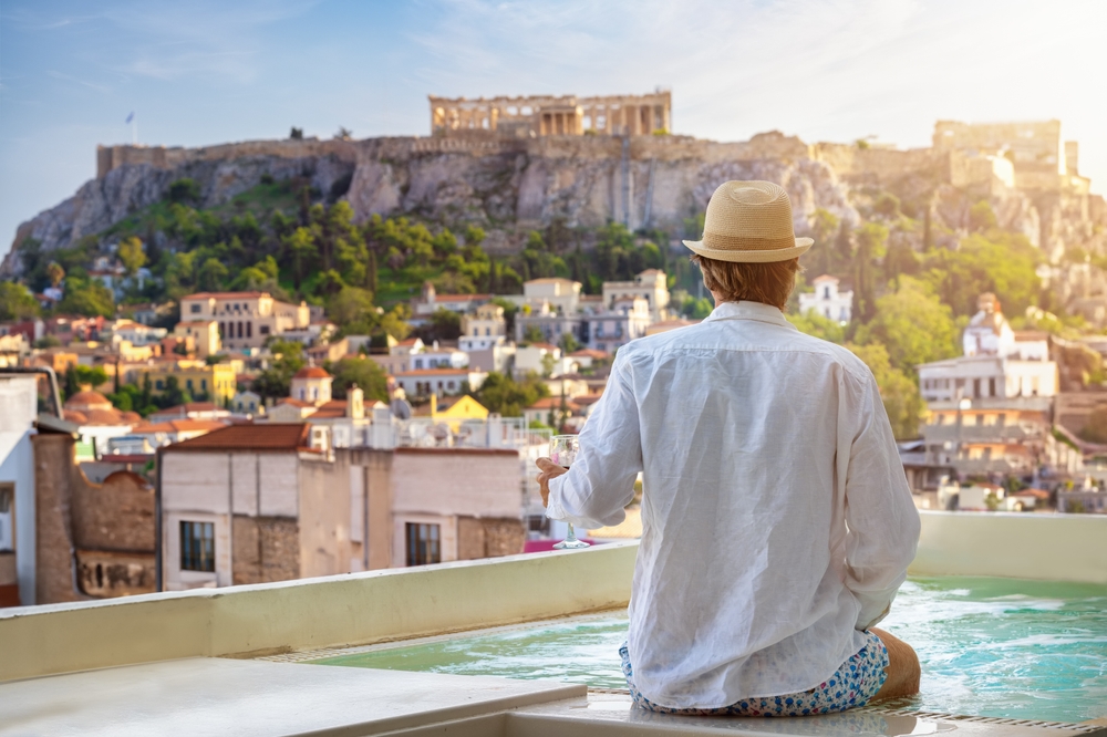 A,tourist,man,sitting,by,the,pool,enjoys,the,view