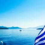 Greek,flag,blowing,on,sailing,boat,in,ionian,sea,greece
