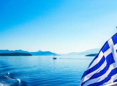 Greek,flag,blowing,on,sailing,boat,in,ionian,sea,greece